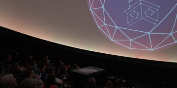 Planetarium audience learns about recent news in the world of astronomy.