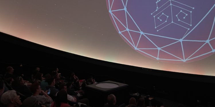 Planetarium audience learns about recent news in the world of astronomy.