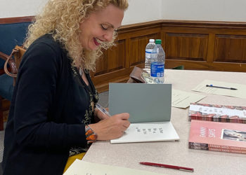 Brown signs books after her speaking engagement