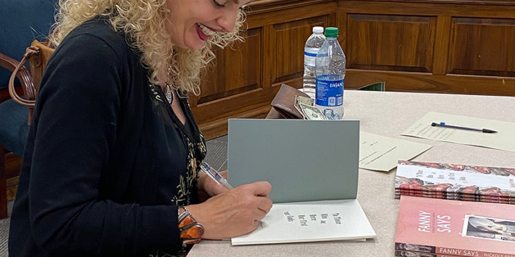 Brown signs books after her speaking engagement