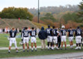 Samford Bulldogs stand on the sidelines, ready to play.