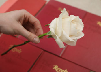 White roses were handed out across campus to promote the app's upcoming launch.