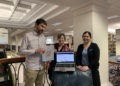 Lance Day (left), Lauren Young (center) and Sarah Cooper (right) show off library resources.
