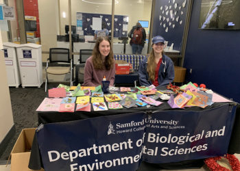 Madeline Thompson (left) and Shelby Kuck (right) sell homemade cards for Valentine's Day.