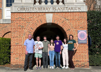 Students present at planetarium show about objects in the universe.
