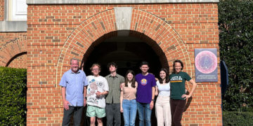 Students present at planetarium show about objects in the universe.